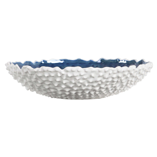 White Ceramic Bowl With Heavy Outer Texture And A Bright Blue Interior Glaze.