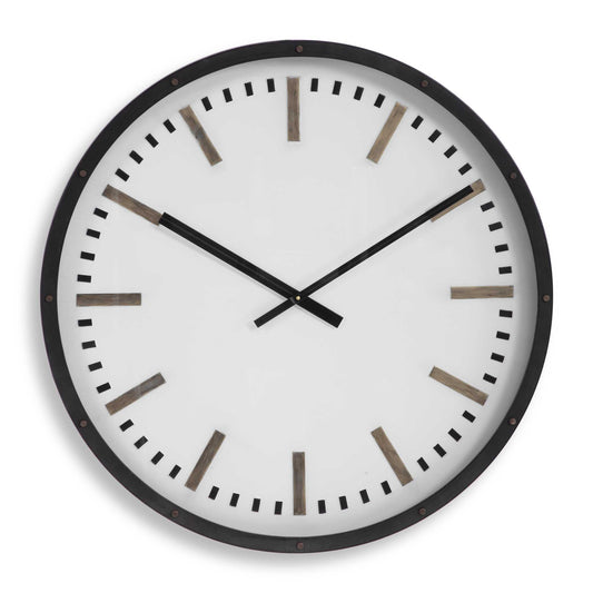 Wall Clock Featuring A Dark Bronze Frame With Nail Head Accents. The White, Iron Face With Antique Brass And Black Accents Are Encased Under A Glass. Quartz Movement Ensures Accurate Timekeeping. Requires One "AA" Battery.