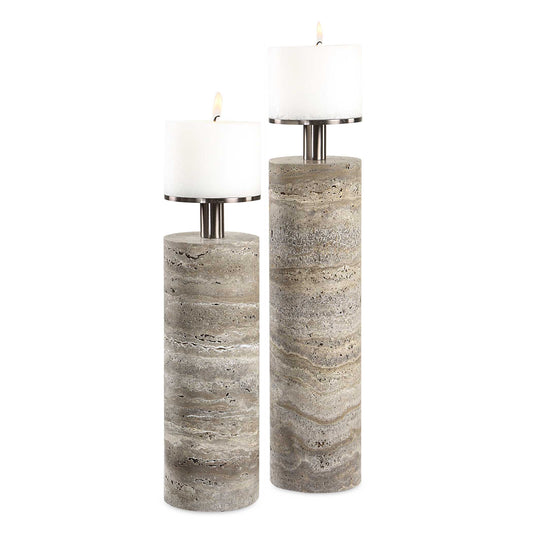 Illuminate Your Space With Sophistication Using These Cylinders Of Unfilled Gray Travertine Featuring Dark Bronze Metal Candle Cups. Crafted For Elegance And Durability, These Candleholders Add A Touch Of Refined Ambiance To Any Room. Since It Is A Natural Stone, Each Piece Of Travertine Is Unique. Two 4"x3" White Candles Included. Sizes: S-4x13x4, L-4x16x4