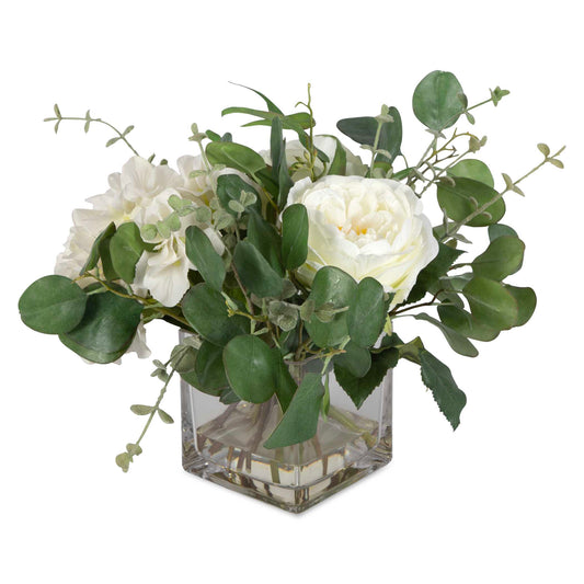 An Airy Mix As If Freshly Cut From The Garden, Featuring Cream Hydrangeas, Roses, Eucalyptus Placed Into A Glass Vase With Faux Water.