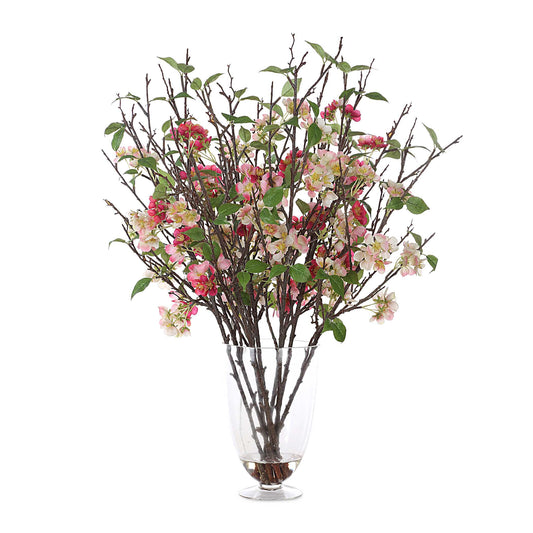 Vibrant Spring Blooms Of Petite Cherry Blossoms In Ivory And Blush Tones Create A Lush Centerpiece, Arranged In A Glass Pedestal Vase With Faux Water.