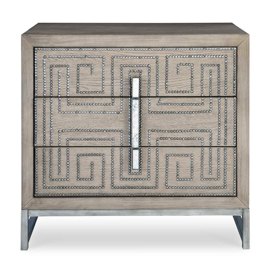 Layered In Oak Veneer In A Soft Mushroom Gray Finish, This Solid Wood Three Drawer Chest Showcases A Geometric Studded Design Finished In Aged Pewter Paired With Mirror Accented Hardware Atop A Coordinating Solid Iron Base.