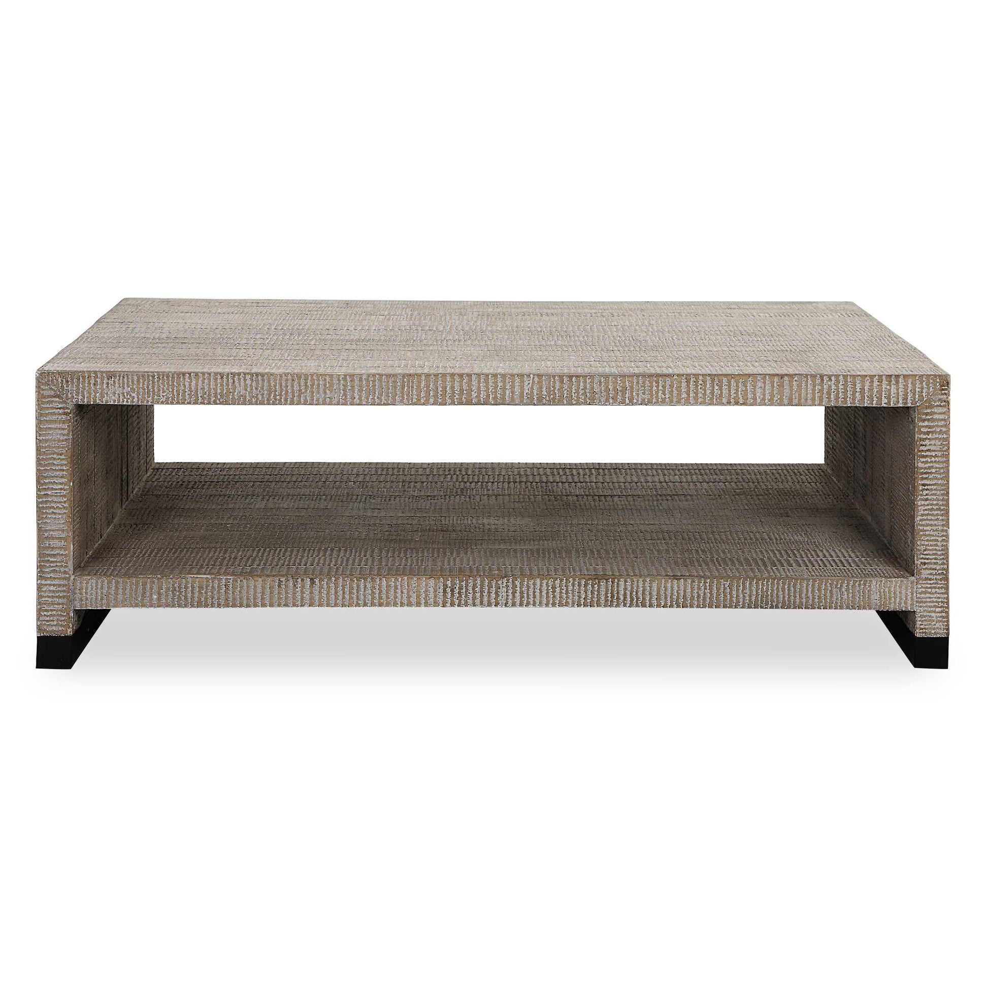 This Casual Coffee Table Provides Ample Display Space And Creates A Rustic Feel With Its Natural Wood Finish And Intricate Carved Details, Highlighted By A White Washed Glaze. Steel Feet Are Finished In A Natural Aged Black.