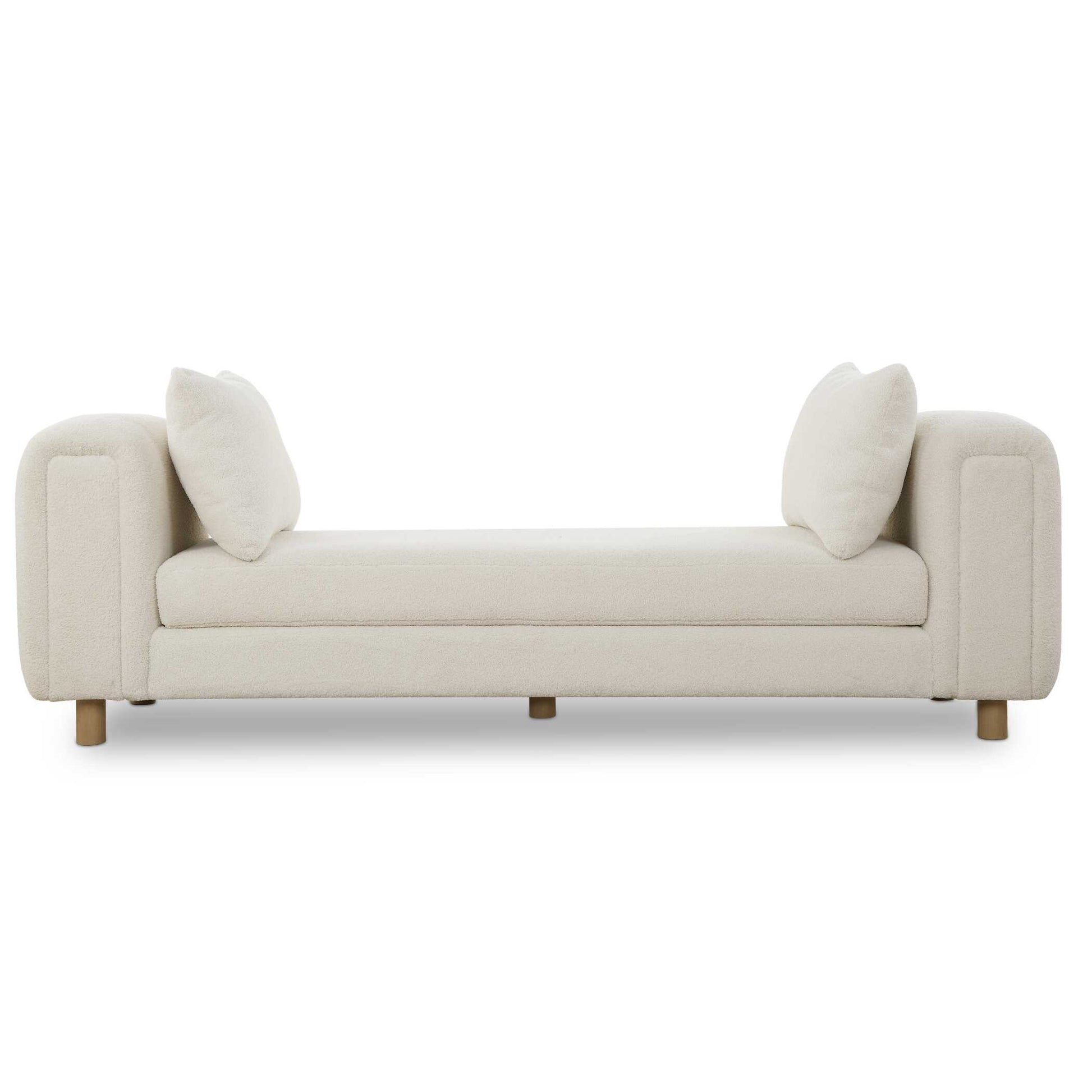Exceptional Comfort With Dual Functionality As An Oversized Bench Or Even A Small Day Bed, Featuring Chunky Curves And Dowel Feet In Light Oak, With Two Accent Pillows. Upholstered In A Finely Textured Faux Sheepskin In Soft Ivory.