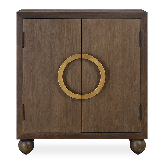 Simple And Sophisticated, Mayenne Beautifully Displays Rich Oak Wood Grain Quickly Elevating Any Room. This Two Door Cabinet Captivates With Its Circular Metal Handle In An Antiqued Gold Leaf Finish All Tied Together By Its Unique Ball Feet.